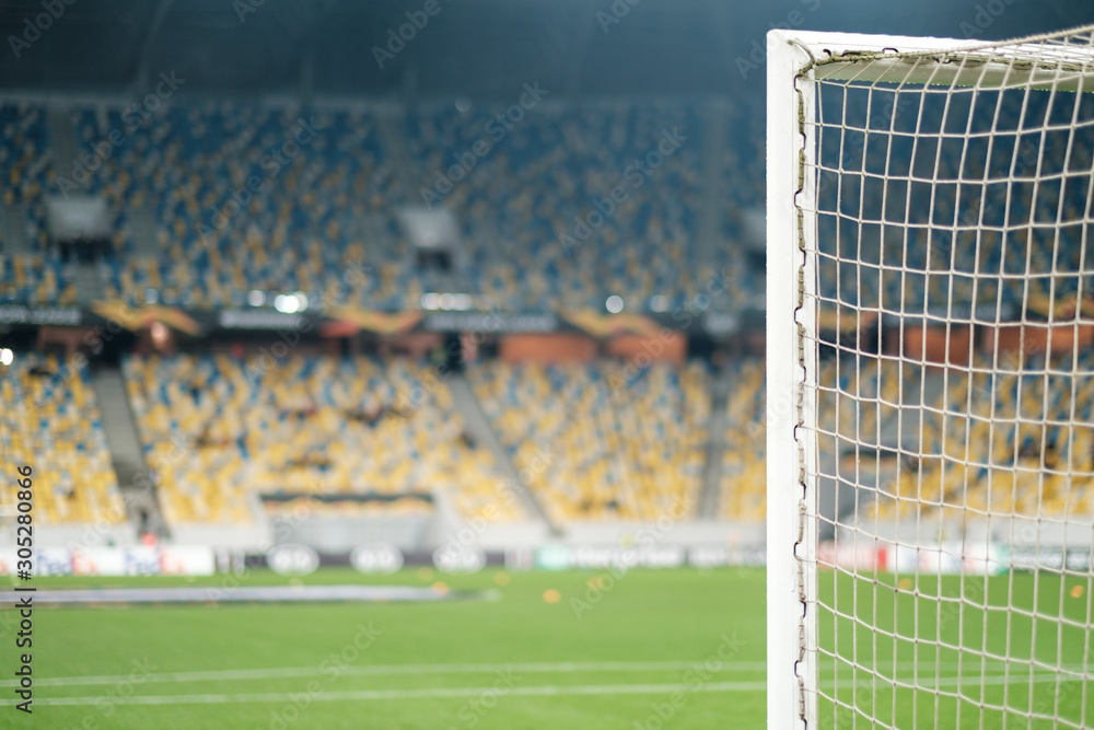 Fototapeta premium Football gate with net and view of stadium. Football game.