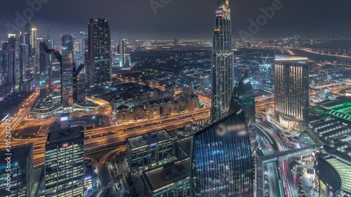 Wallpaper Mural Dubai International Financial Centre district with illuminated modern skyscrapers night timelapse. Aerial view from Downtown with traffic on streets Torontodigital.ca