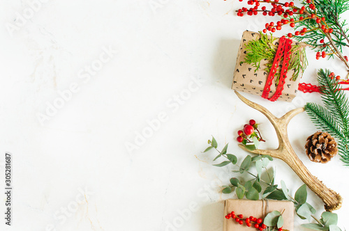 Christmas decorated gift boxes with natural details, deer horns and eucalyptus