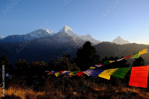 Viewpoint Poon Hill in Ghorapani, Himalaya, Nepal - amazing view of mountains with waving prayer flags. 