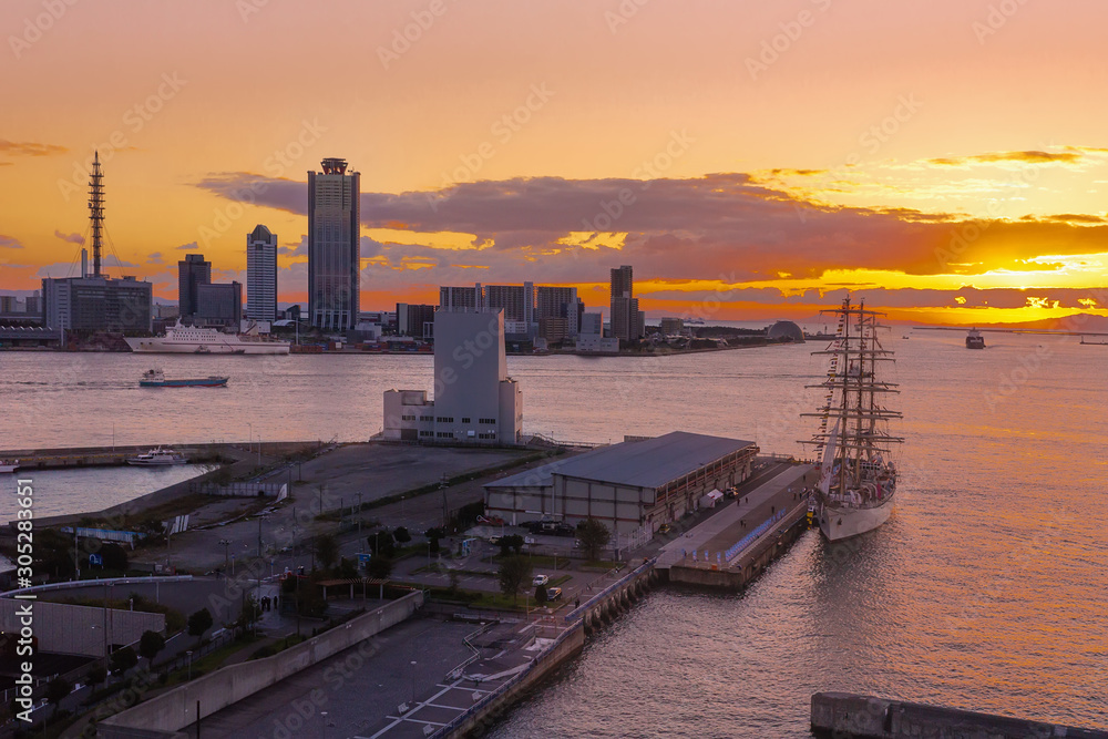 Sunset over Osaka Bay with boats, sailboat and the city view.