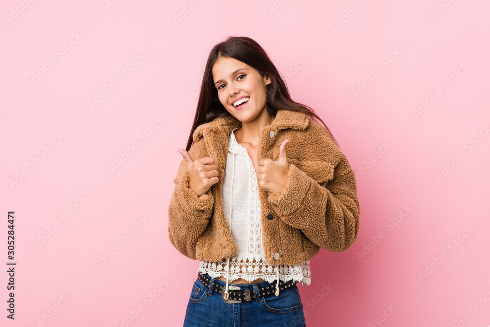 Young cute woman raising both thumbs up, smiling and confident. Young cute woman raising both thumbs up, smiling and confident.