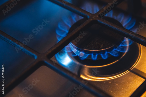 Tableau sur toile close-up of a gas burner on a stove in the kitchen