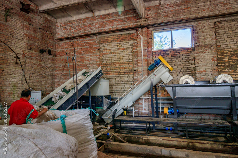 Fototapeta premium Loading plastic bags and film into the cleaning and plastic machine