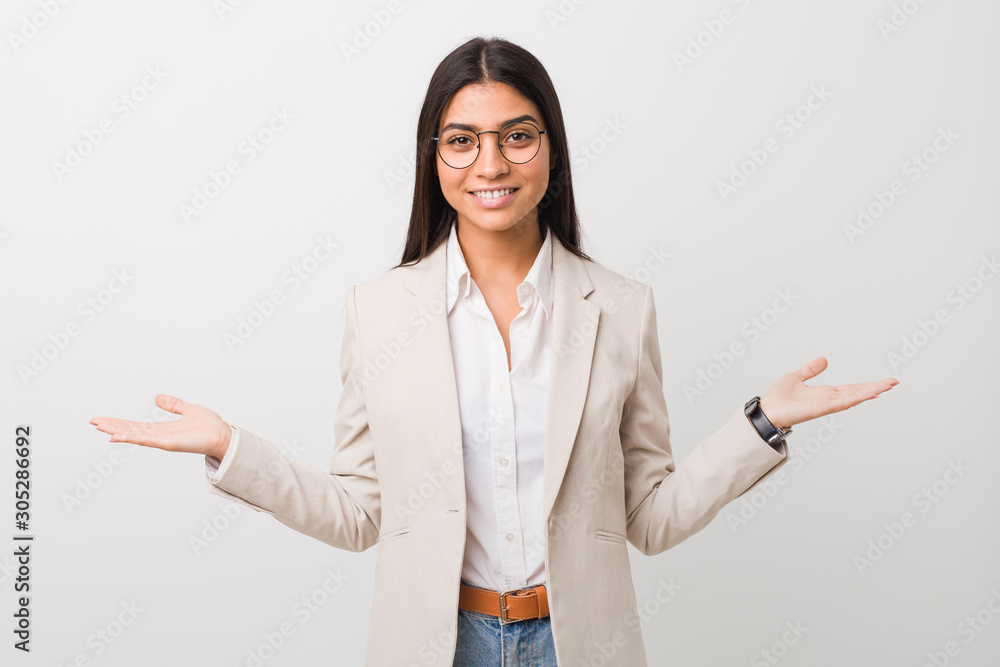 Young business arab woman isolated against a white background showing a welcome expression. Young business arab woman isolated against a white background showing a welcome expression.