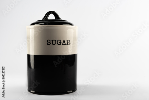A porcelain sugar storage container photographed on white background