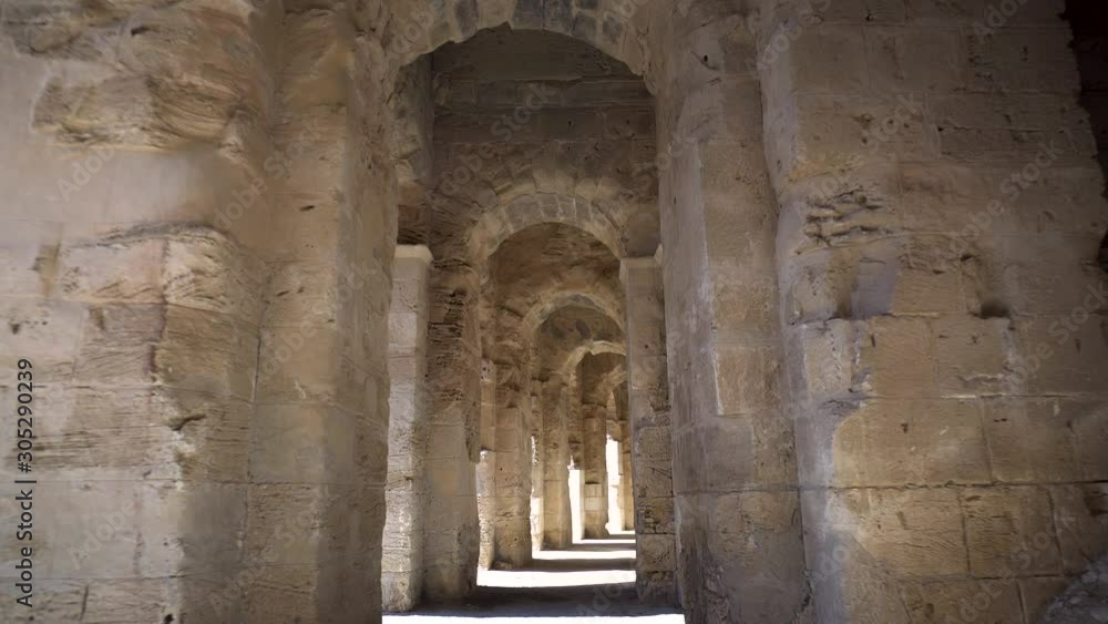 Ancient Roman ruins. Ancient Amphitheater located in El Jem, Tunis. The passage between the columns. Historic Landmark. Ancient Roman ruins. Ancient Amphitheater located in El Jem, Tunis. The passage between the columns. Historic Landmark.