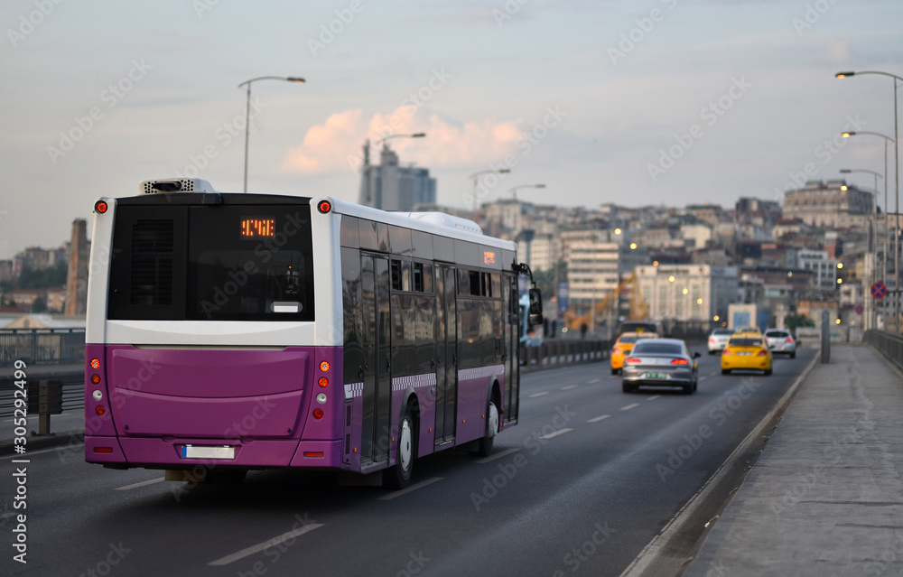 Evening cItyscape scene with public route bus which pass across Ataturk Bridge in city traffic