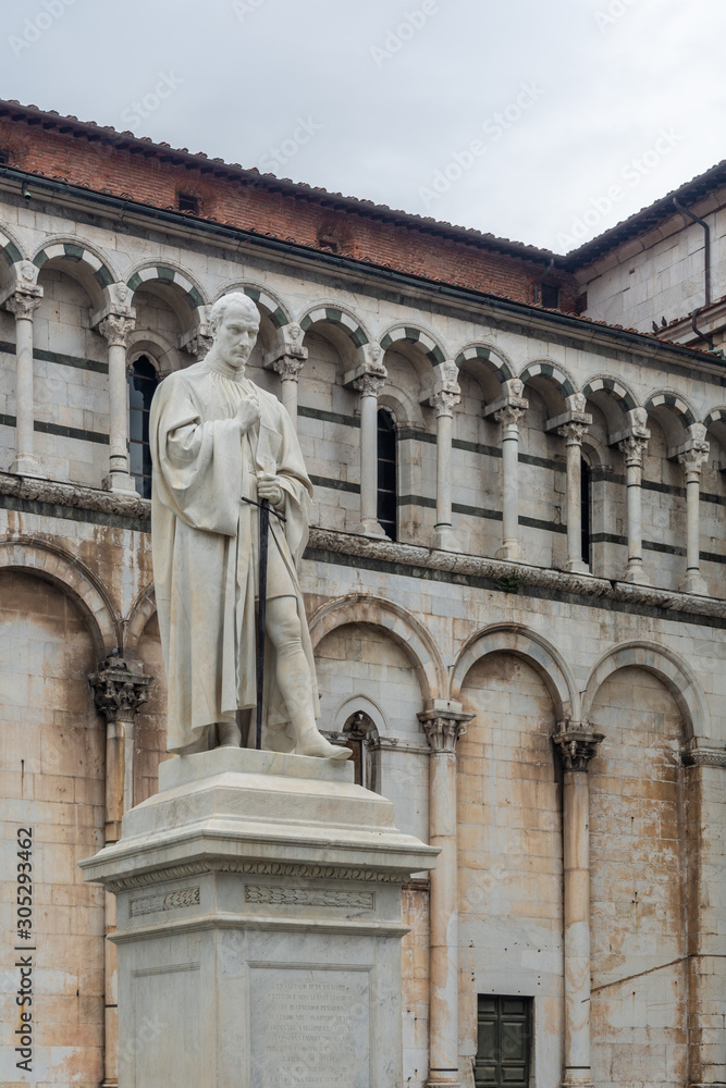 The statue of Michael the Archangel and the basilic of San Michele in Foro in Lucca