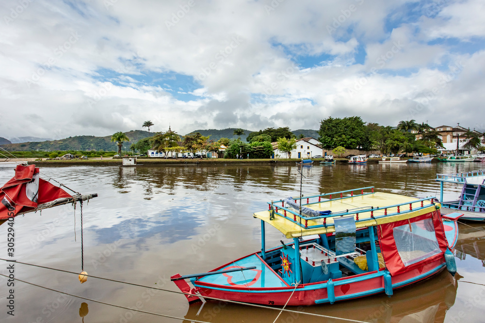 Boat dock at Paraty Bay in Rio de Janeiro, Brazil, where passenger boats await tourists to be taken to nearby islands or other villages.