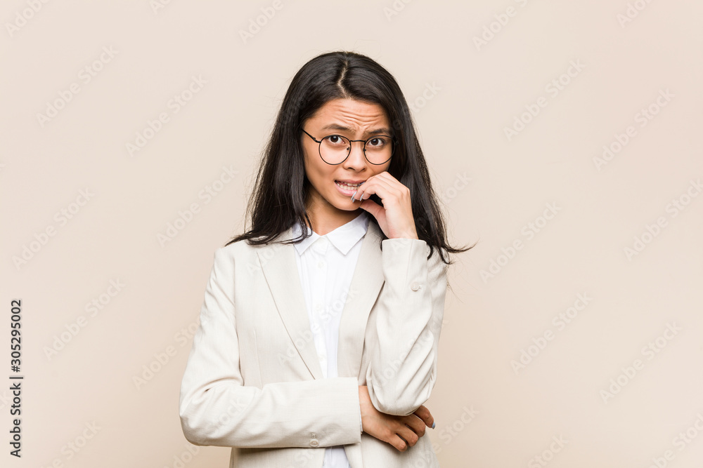 Young business chinese woman biting fingernails, nervous and very anxious. Young business chinese woman biting fingernails, nervous and very anxious.