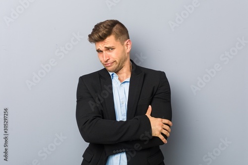 Young handsome caucasian man unhappy looking in camera with sarcastic expression.
