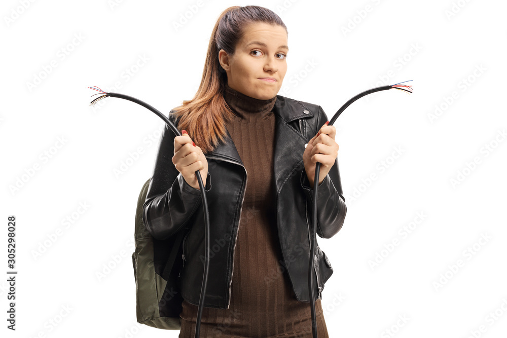 Confused young female holding a cut electrical cable Confused young female holding a cut electrical cable