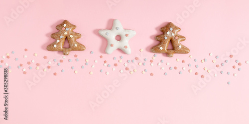 Christmas sweet composition. Xmas gingerbread cookies on pastel pink background. Christmas, New Year, winter concept. Flat lay, top view, copy space © prime1001