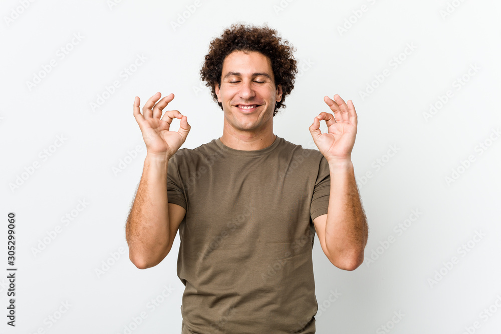 Mature handsome man isolated relaxes after hard working day, she is performing yoga. Mature handsome man isolated relaxes after hard working day, she is performing yoga.