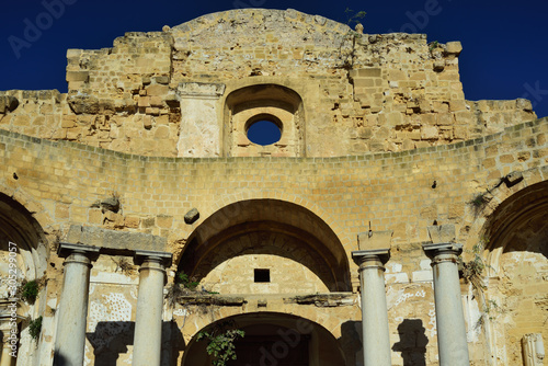 Ruin of the former church sant Ignazio, Mazara del Vallo, Sicily, Italy, with pillars and wall in front of blue sky with no roof or ceiling