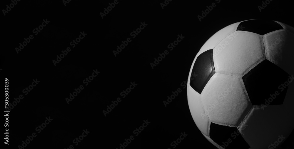 Obraz premium Closeup of football ball on black background