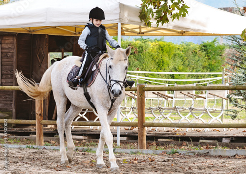 Portrait of equestrian boy riding a horse