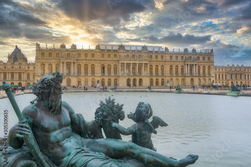 Sculptures and pond in front of the Royal palace in Versailles, France