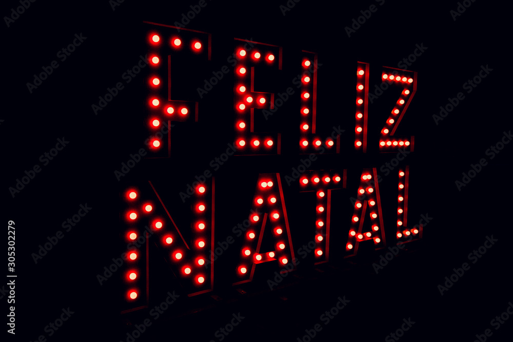 Merry christmas written in portuguese on neon red light black background Merry christmas written in portuguese on neon red light black background