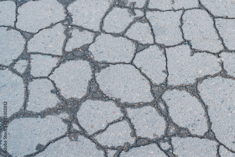 A fragment of cracked old asphalt A fragment of cracked old asphalt