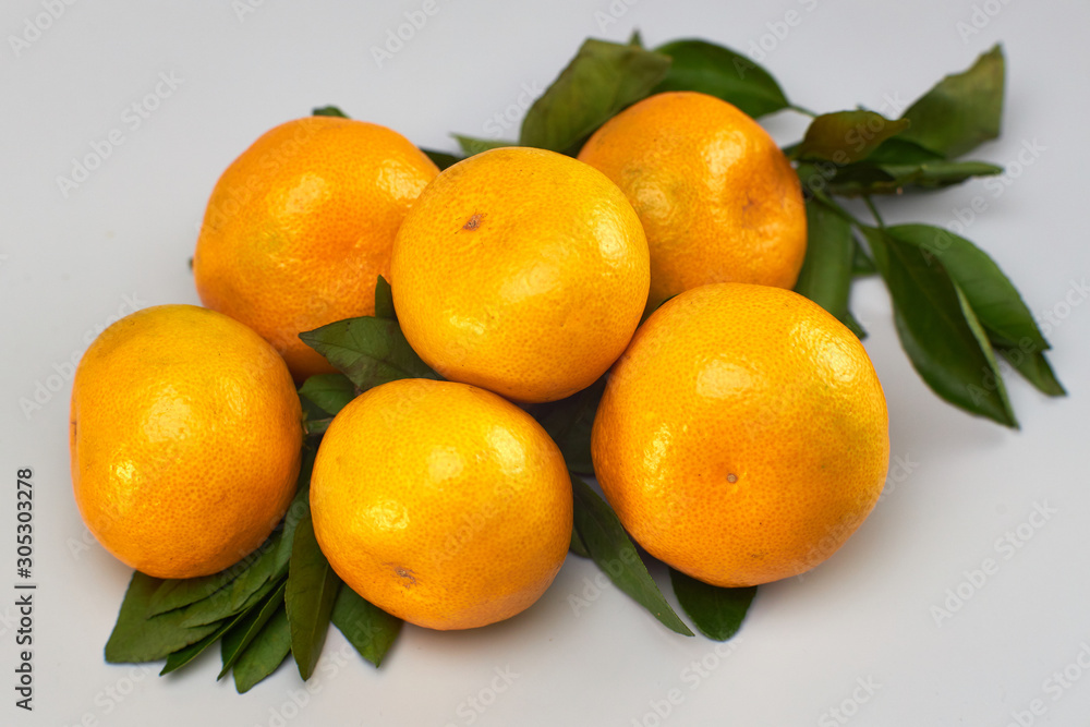 Tangerines with leaves on a light background Tangerines with leaves on a light background