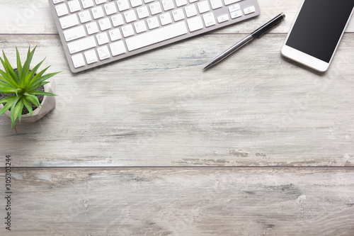 White desk office with laptop, smartphone and other work supplies with cup of coffee. Top view with copy space for input the text. Designer workspace on desk table essential elements on flat lay