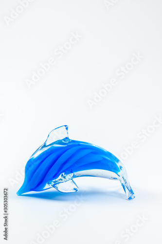 Blue glass dolphin on white background 