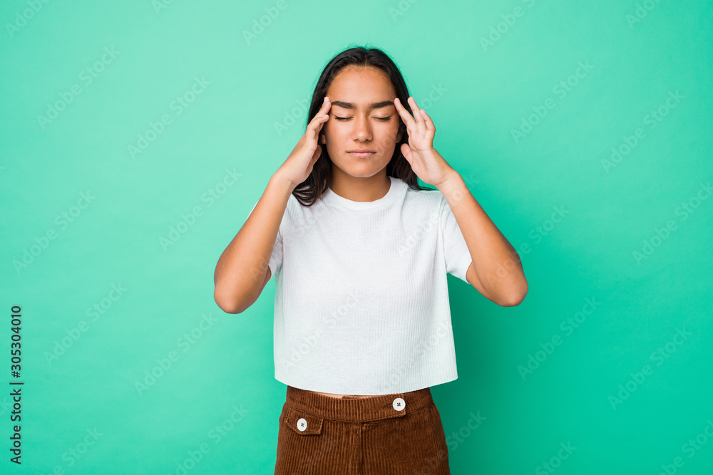 Young mixed race indian woman isolated touching temples and having headache. Young mixed race indian woman isolated touching temples and having headache.