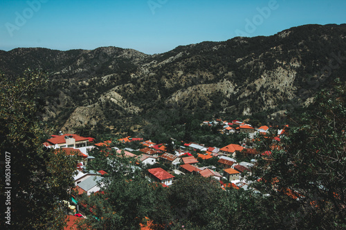 Orange roofs. Panoramic view near of Kato Lefkara - is the most famous village in the Troodos Mountains. Limassol district, Cyprus, Mediterranean Sea. Mountain landscape and sunny day. photo