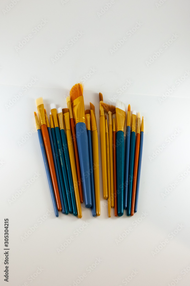 Bunch of paintbrushes laying on a white background Bunch of paintbrushes laying on a white background