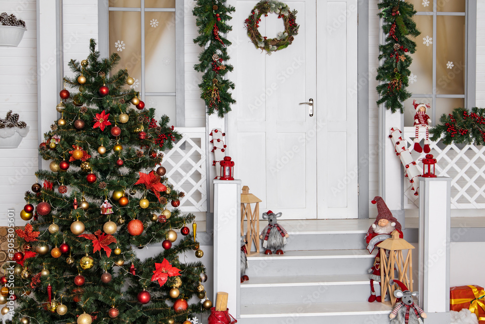 Christmas background festive studio decoration of white porch wooden  exterior house with holiday tree and colorful toys Stock Photo | Adobe Stock
