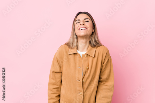 Young caucasian woman isolated relaxed and happy laughing, neck stretched showing teeth. © Asier