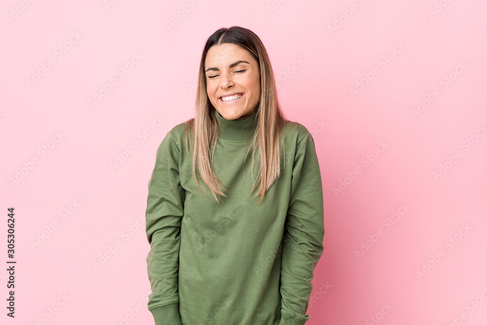 Young caucasian woman isolated laughs and closes eyes, feels relaxed and happy.