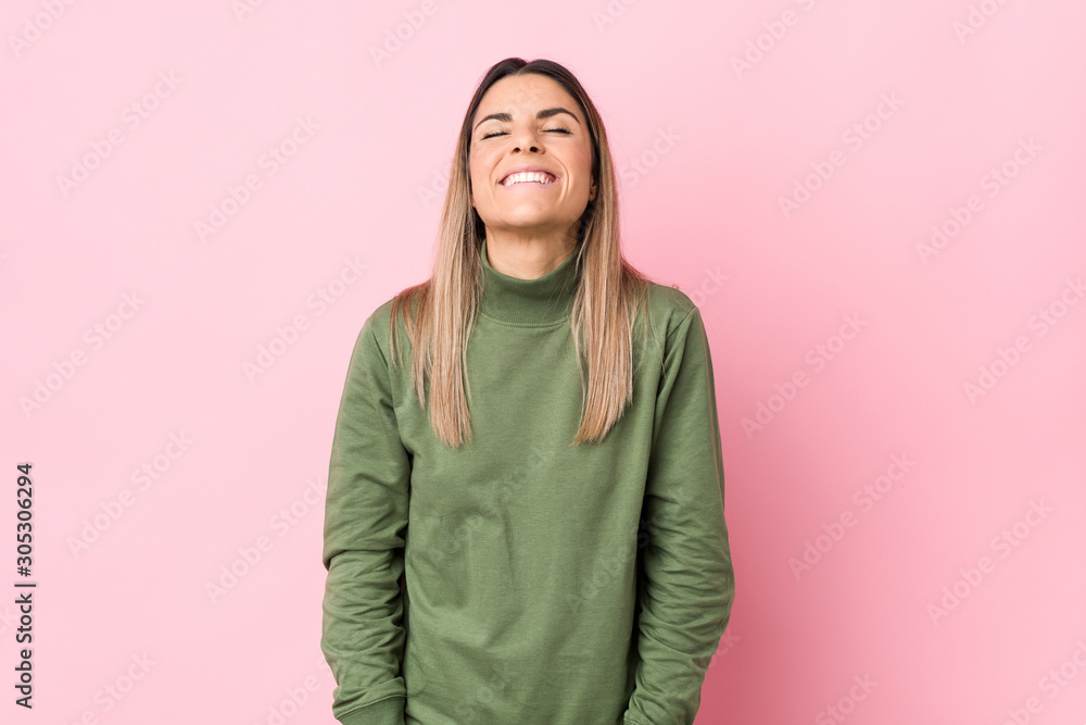 Young caucasian woman isolated relaxed and happy laughing, neck stretched showing teeth. Young caucasian woman isolated relaxed and happy laughing, neck stretched showing teeth.