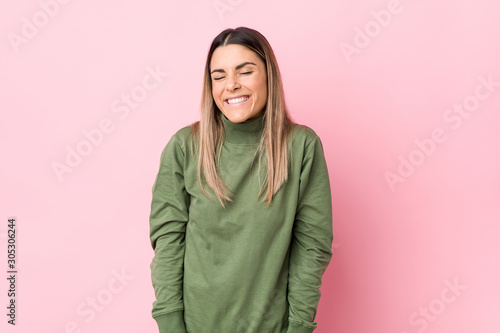 Young caucasian woman isolated laughs and closes eyes, feels relaxed and happy. © Asier