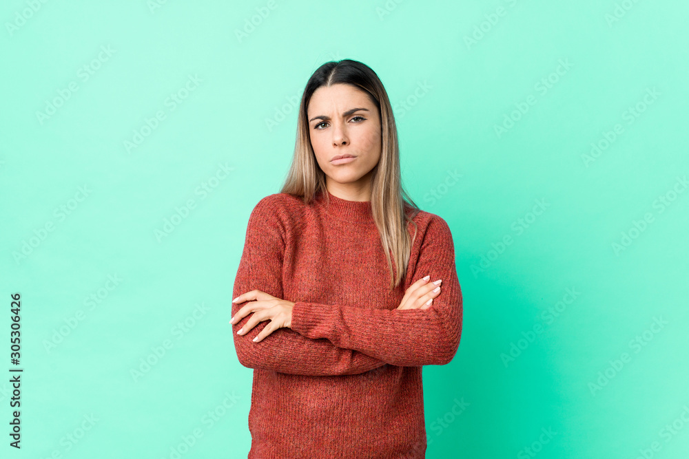 Fototapeta premium Young caucasian woman isolated frowning face in displeasure, keeps arms folded.