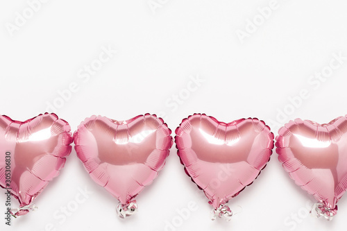 Pink air balloons heart shape on a white background. Concept wedding, valentines day, photo zone, lovers. Banner. Flat lay, top view