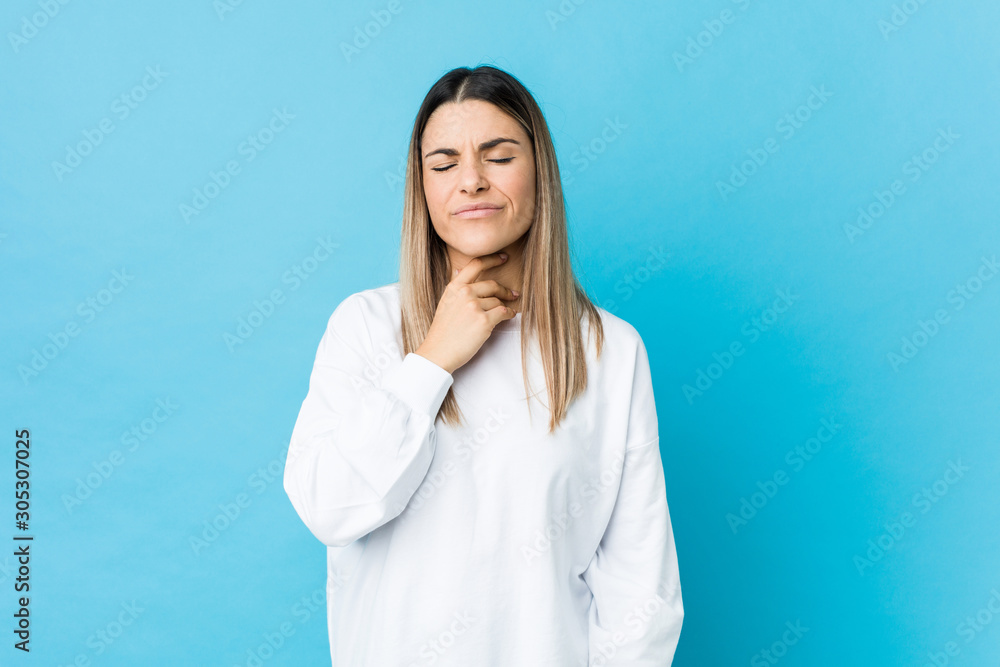 Young caucasian woman isolated suffers pain in throat due a virus or infection. Young caucasian woman isolated suffers pain in throat due a virus or infection.