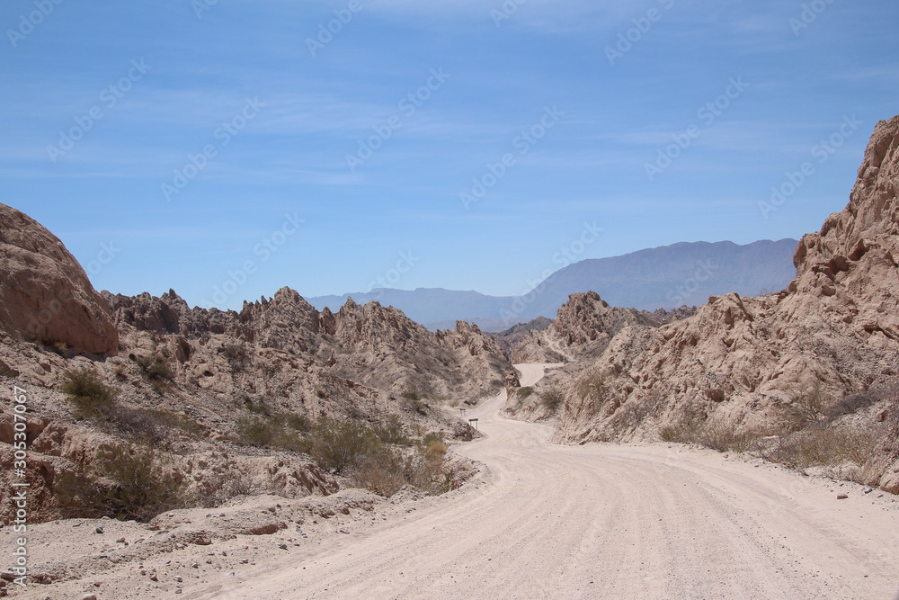 A road crosses between the rocky peaks of La Quebrada de las flechas, Argentina A road crosses between the rocky peaks of La Quebrada de las flechas, Argentina