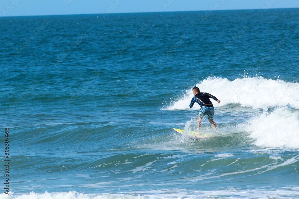 Man surfing on a wave in Daytona Beach, FL Man surfing on a wave in Daytona Beach, FL