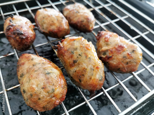 Traditional Cypriot food. Sheftalia : Cypriot Lamb and Pork Sausages on a metal grill. photo