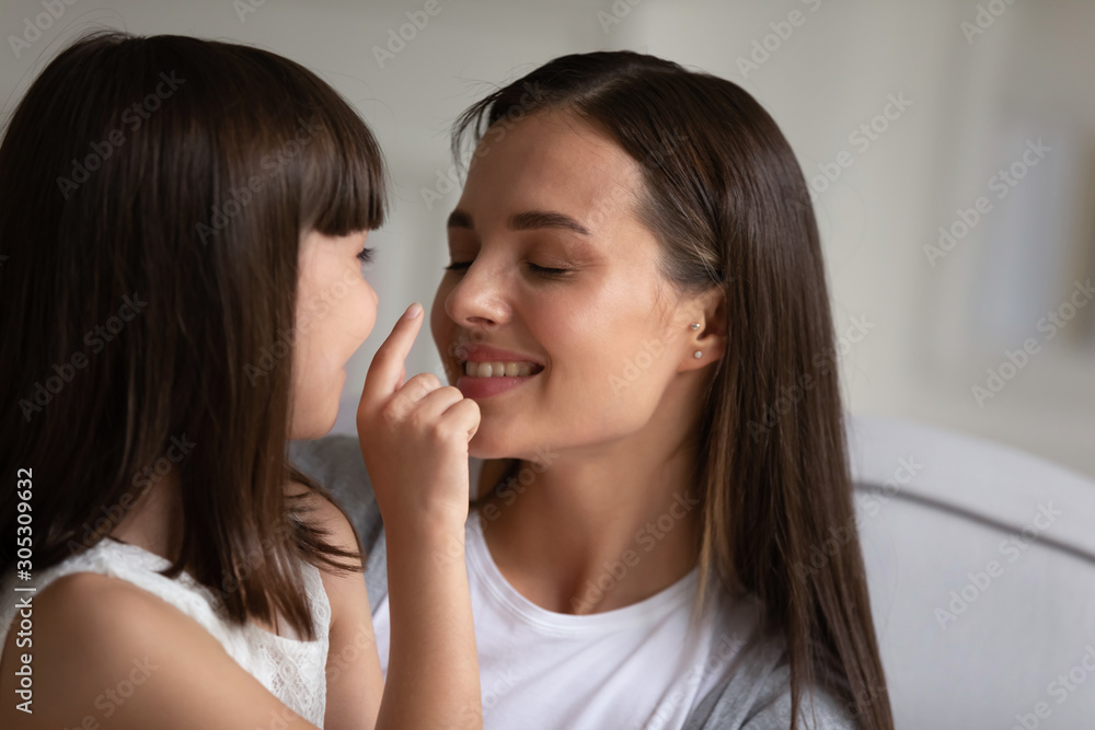 Child enjoy time with mom touch her face showing love Child enjoy time with mom touch her face showing love