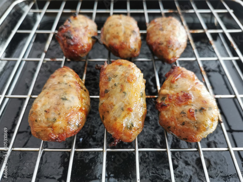 Traditional Cypriot food. Sheftalia : Cypriot Lamb and Pork Sausages on a metal grill.
