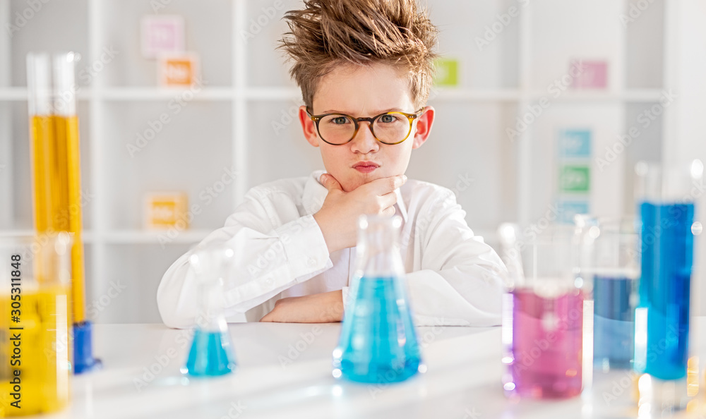 Thoughtful little scientist thinking over problem