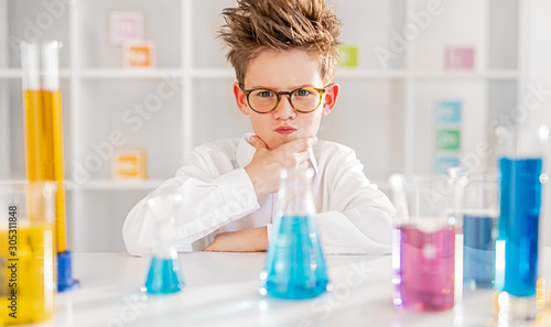 Thoughtful little scientist thinking over problem