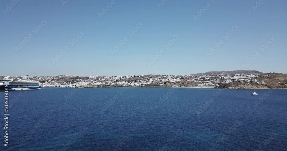Drone parallax aerial view of a cruise ship which is sailing in the crystal clear water Drone parallax aerial view of a cruise ship which is sailing in the crystal clear water