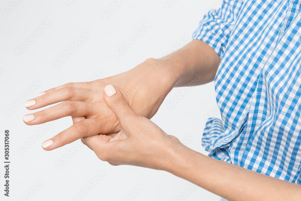 Woman suffering from pain and weakness in palm. Massage and kneading of