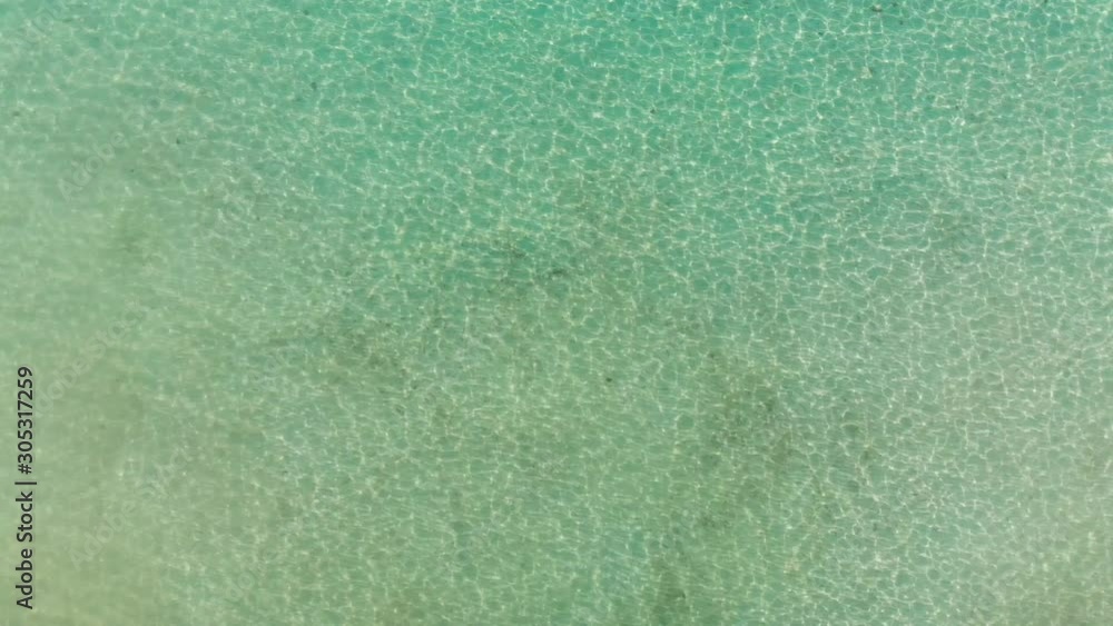 Sun reflection and Light glare in ocean water. Blue transparent water surface background Sun reflection and Light glare in ocean water. Blue transparent water surface background