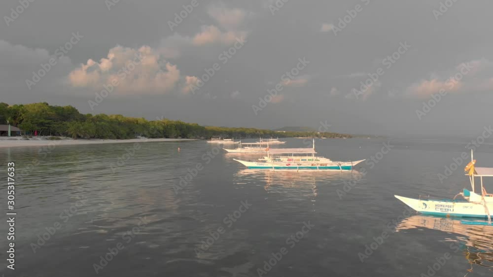 Empty sightseeing boats stand near the sand shore the sunset. Cinematic close view. Empty sightseeing boats stand near the sand shore the sunset. Cinematic close view.